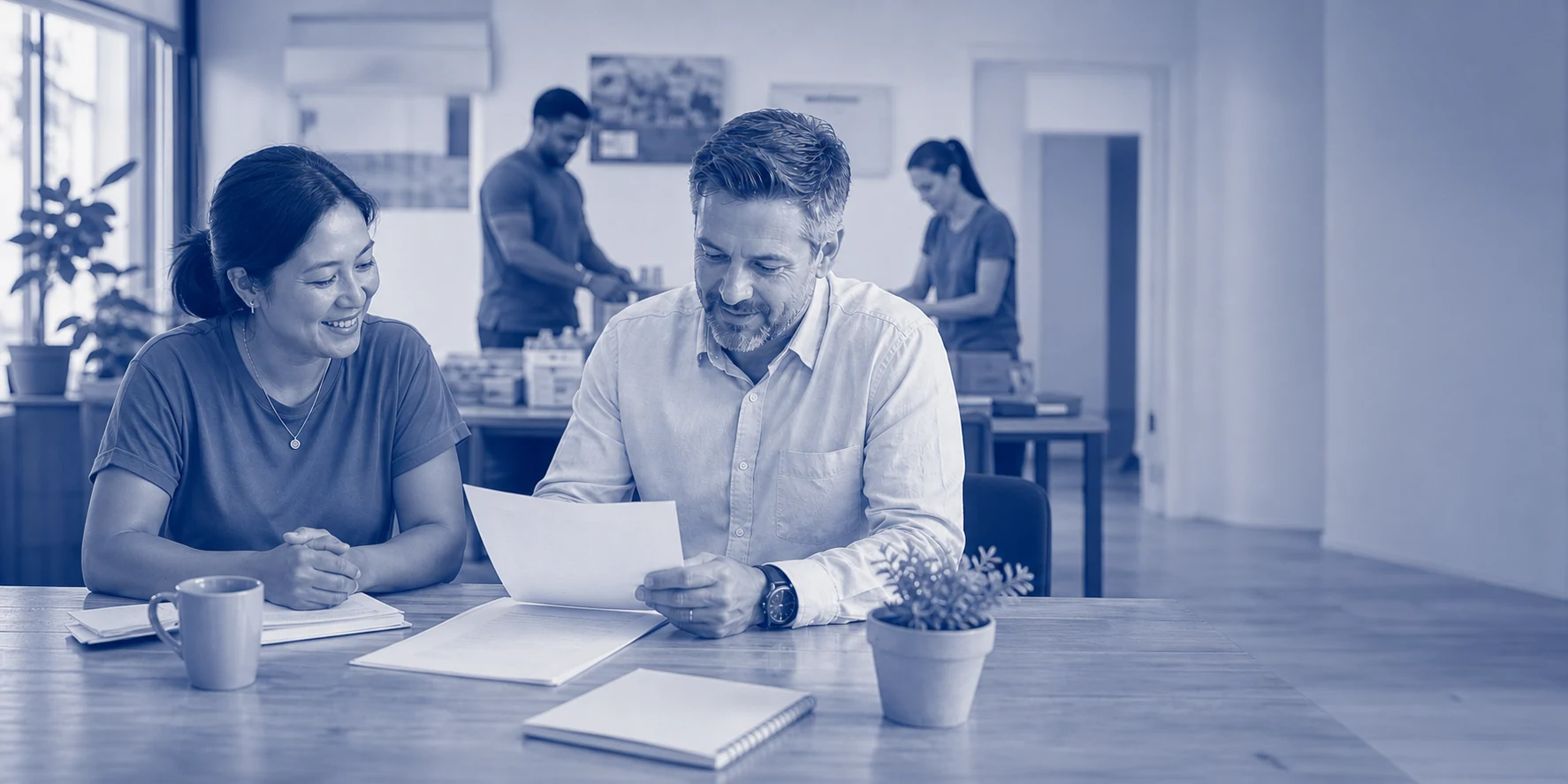 A nonprofit director and CPA reviewing reinstatement documents together